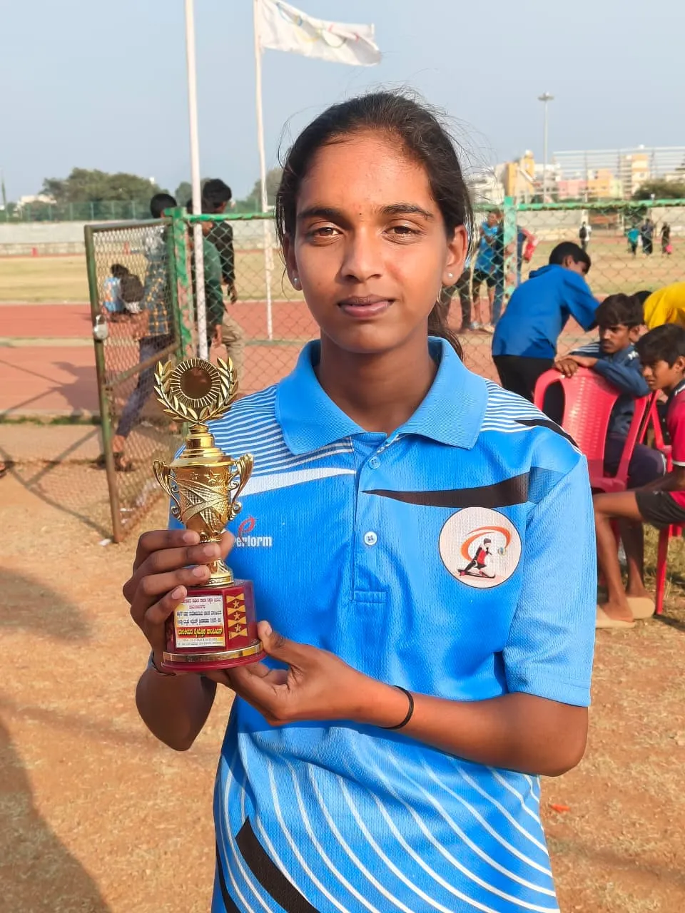 Gauri proudly holding her first-place sports trophy close-up - Aakar Social Ventures Field Story