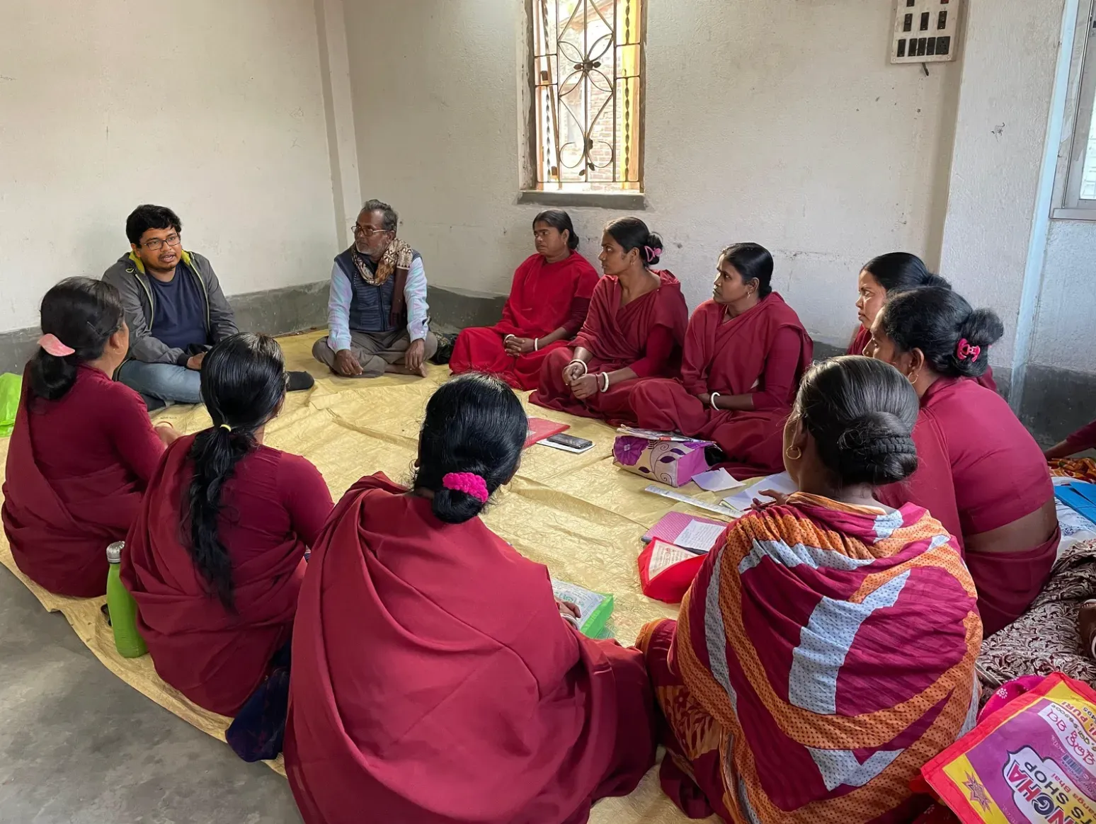 A group of women in a community setting engaged in empowerment activities by Aakar Social Ventures.